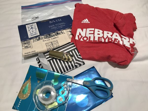 For my mom, we brought a tea towel from our trip to Bath, England, last summer, a Nebraska volleyball shirt, and her favorite perfume. I pre-measured pieces of wrapping paper before we left, and brought tape and scissors in my suitcase. 