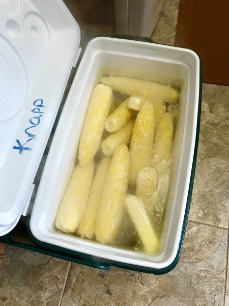 We learned a great way to make sweet corn for a crowd is to pour boiling water over the corn in a cooler and just shut the lid for about 20 minutes.