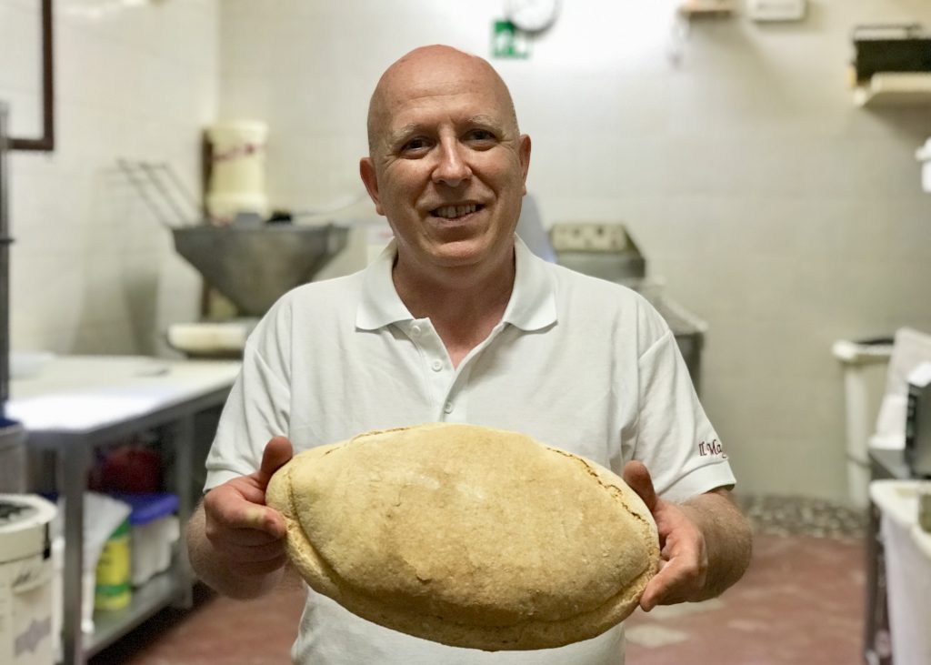 Owner and baker Lorenzo at his bakery in Siena, Italy.