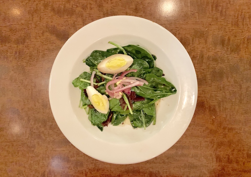 Wilted spinach salad with soy marinated eggs.