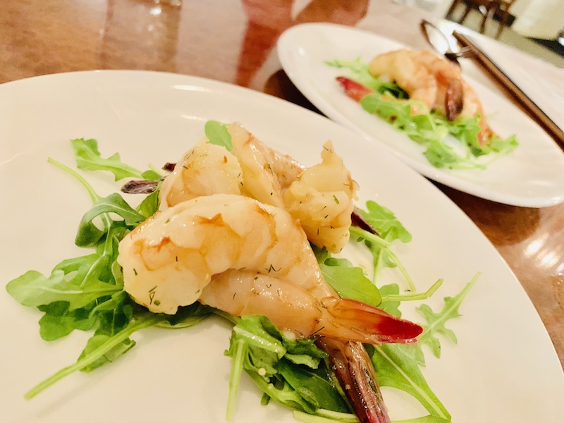 Grilled marinated shrimp with arugula.