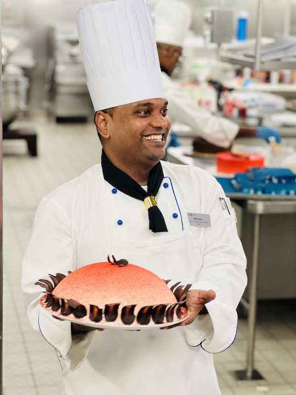 Chef Mohan with pastry in galley Celebrity Reflection